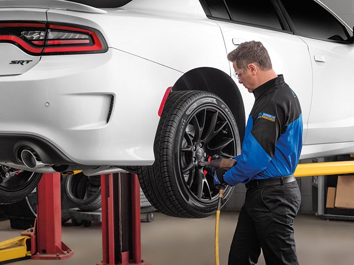 A gross auto technician working on a vehicle